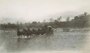 Stagecoach fording a river
